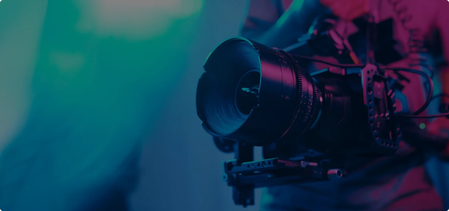 Professional videography camera under blue and pink neon lights